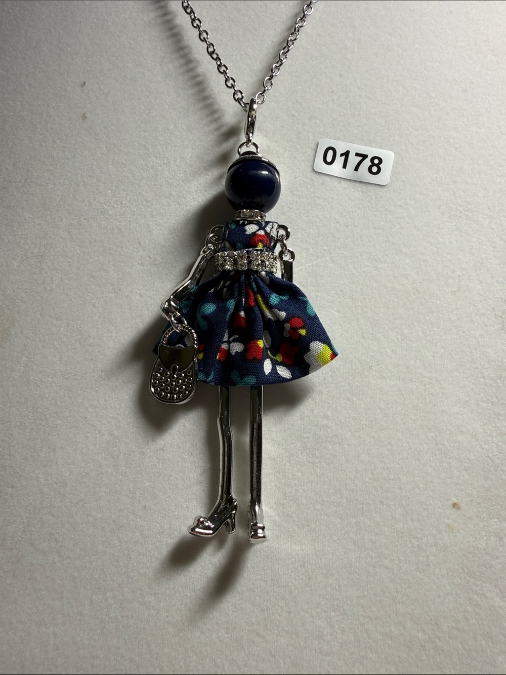 Silver Doll Pendant Necklace with Navy Floral Dress